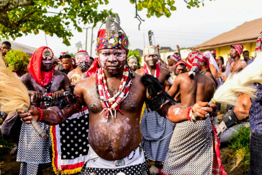 The lead dancer of an Ugelemkpa dance troupe in Nigeria, followed by the group