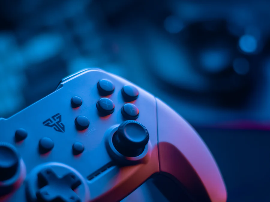 A video game controller lit with blue light